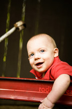 Happy toddler boy in wagon