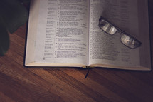 reading glasses on an open Bible 