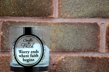 Candle of Faith, Worry ends where faith begins, candle, brick wall