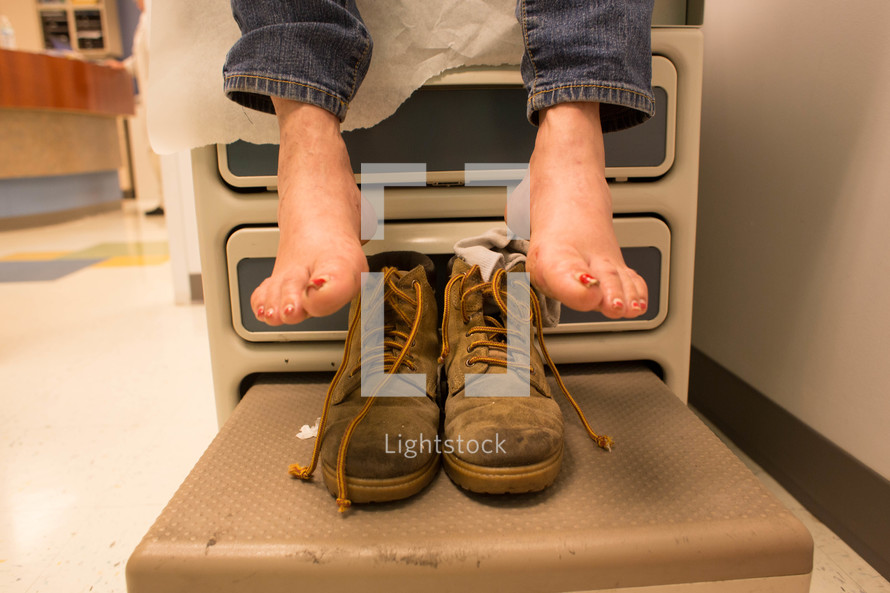 woman's feet and shoes as she sits in a hospital exam room