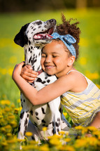 a girl hugging a dog 