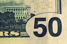 An extreme closeup of a fifty dollar bill