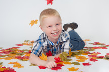 boy child and fall leaves