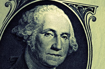 A close up of George Washington on a one dollar bill