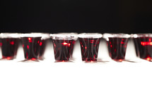 A row of communion cups filled with wine