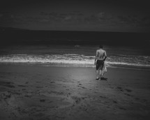 a man standing on a beach in summer 