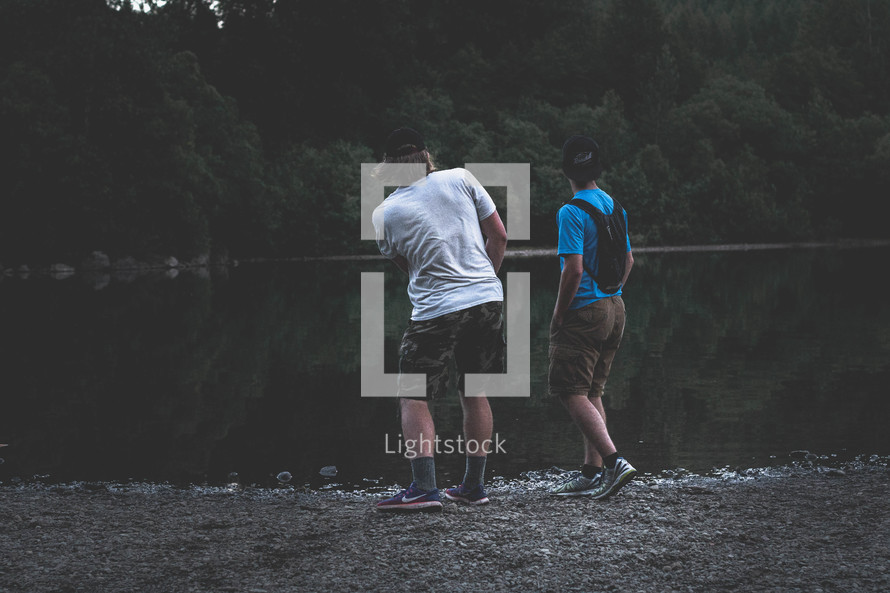 two guys skipping stones 