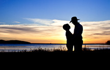 silhouette of a woman and man ln a cowboy hat