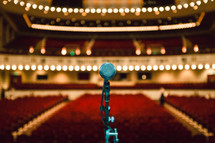 a microphone on stage in an empty auditorium 
