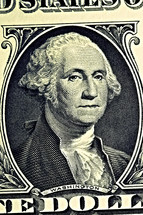 A close up of George Washington on a dollar bill