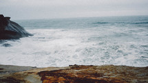 waves in the ocean along a rocky shore 