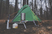 a gas stove beside a tent 