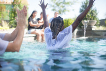 a man being baptized in water 