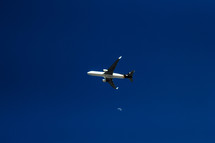 an airplane flying and moon