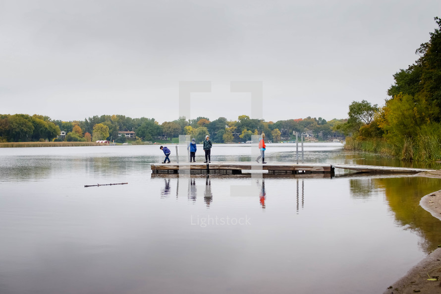 people on a lake dock 