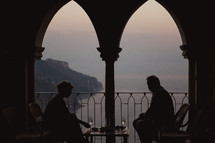 a couple having dinner on a balcony in Italy 