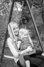 a mother and daughter on a swing 