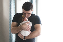 a father holding a newborn 