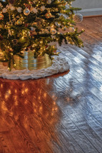 Christmas tree and reflection on a wood floor 