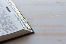 corner of a Bible on a white wood background 