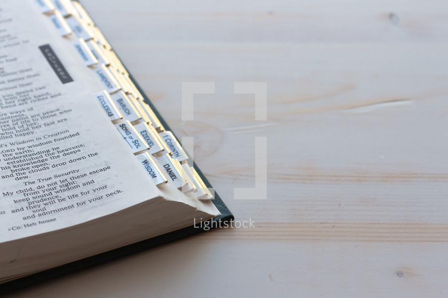 corner of a Bible on a white wood background 