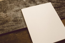 Blank piece of paper on a wooden table.