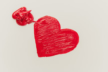 a red heart on white paper 