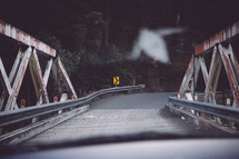crossing a wooden bridge in a car 