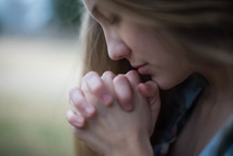 closeup of a woman in prayer 