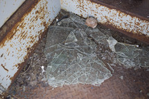 broken glass on a metal floor 