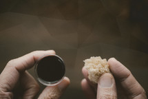 communion wine in a cup and bread against a polygon background 