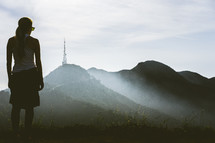 woman looking at fog over mountains
