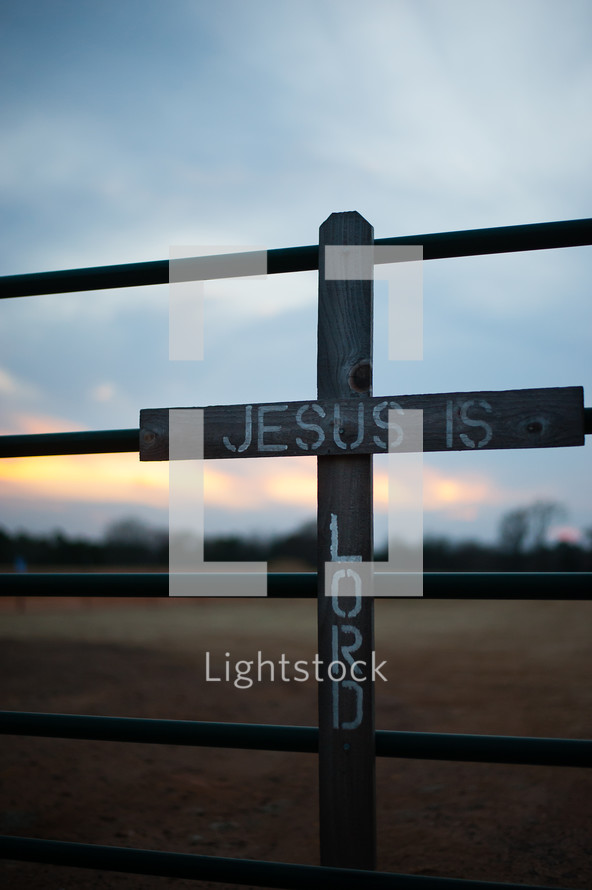Jesus is Lord - words on a cross on a fence 