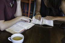 women reading Bibles around a table at a Bible study 