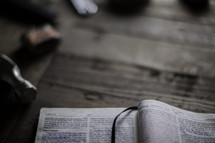 an open Bible on a workbench 