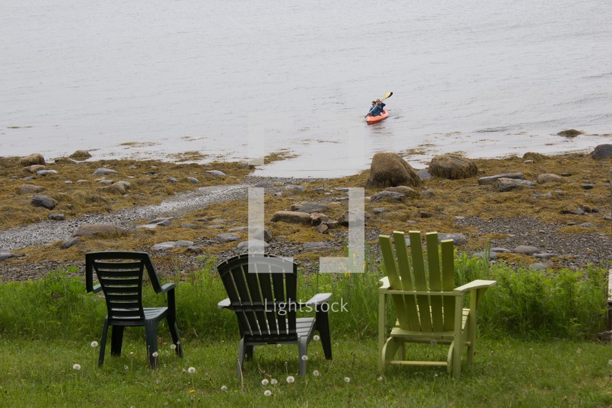 Adirondack chairs overlooking the ocean 