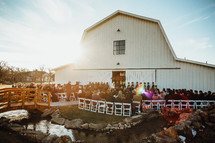 outdoor wedding ceremony by an old barn 