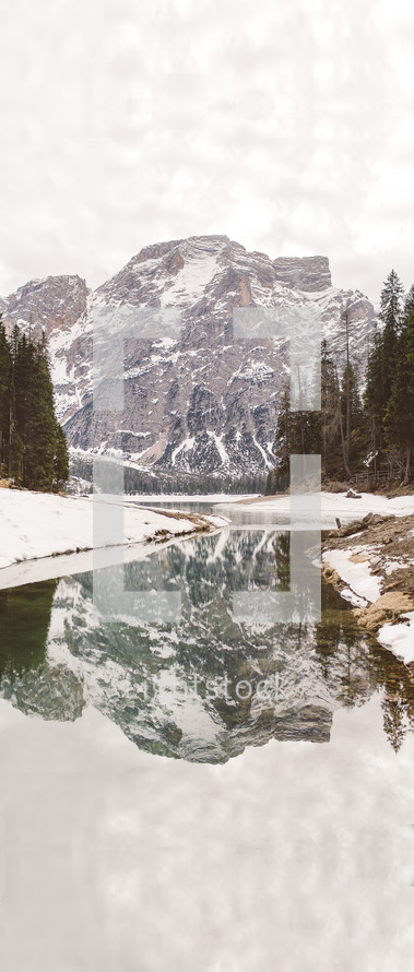 reflection of a mountain with snow in the waters of a river 