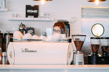 barista making coffee in a coffee shop 