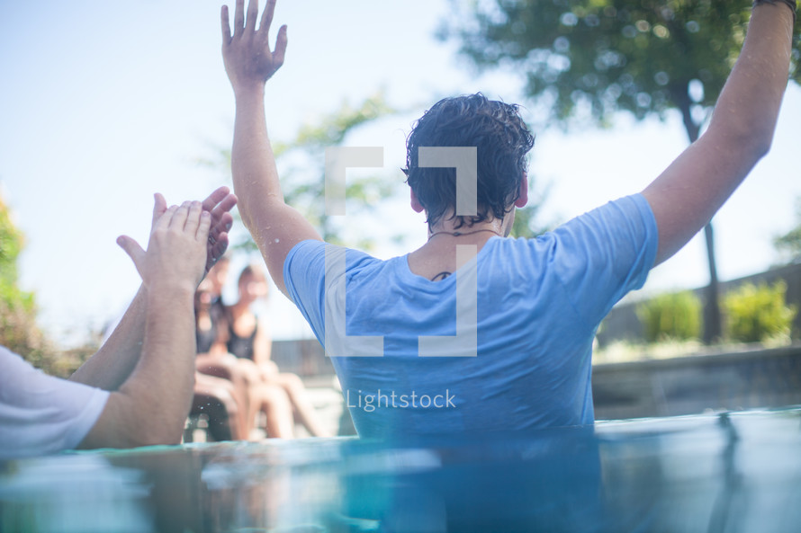 a man being baptized in water 
