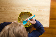toddler boy eating cereal 
