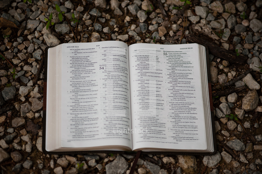 a Bible on gravel 