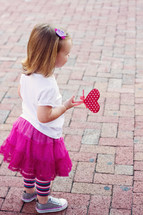 girl toddler holding a heart 