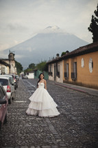 bride in bridal gown on a cobblestone street 