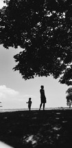 silhouette of a father and son on a beach 