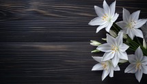 White lily flowers on wooden background. Top view with copy space