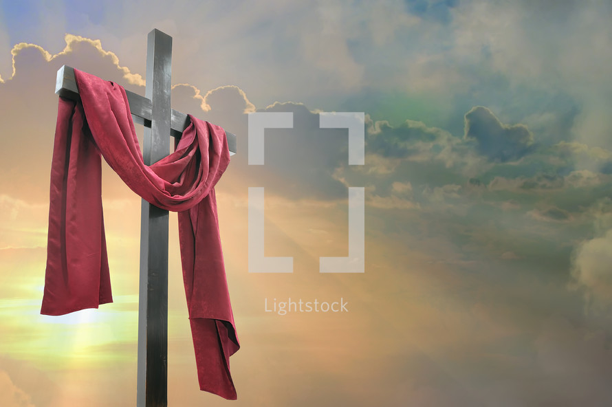 red shroud over a cross at sunrise