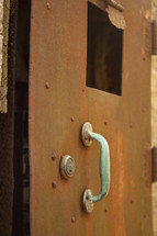 handle on a rusty metal door 
