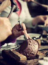 Copper master, hands detail of craftsman at work