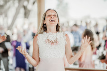 a bride with hands raised praising God 